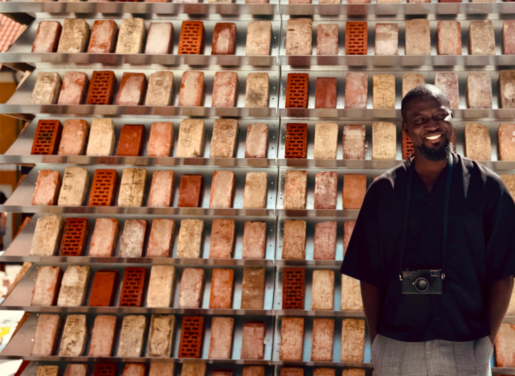 Ghanaian artist Ibrahim Mahama standing beside Labyrinths at MAPS Museum in 2026
