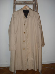 Beige Burberry trench coat on a hanger, photographed in 2009; contextual image, not a view of the V&A exhibition.
